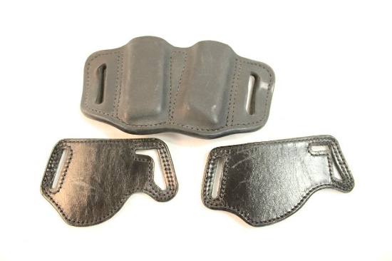 One leather belt double magazine holder, and two Bianchi model 101 foldaway belt slide holster.