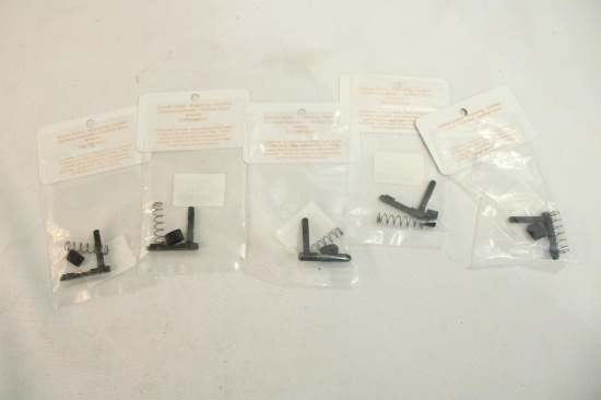 Five AR-15 magazine releases. In packages.