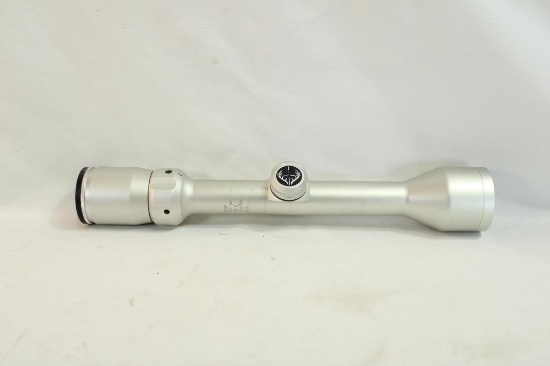 One silver Bushnell 3-9x40 duplex rifle scope with scope covers.