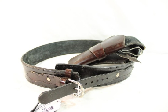 One black leather western style revolver holster and cartridge belt.