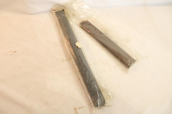 Two extended pistol magazines.