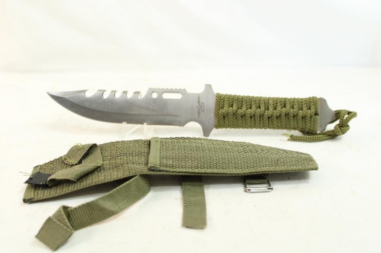 Military knife in sheath with paracord wrapped handle and 6" blade