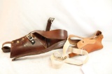 Two leather over the shoulder gun holsters