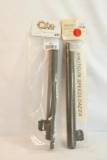 Two shotgun speed loaders, in packages.