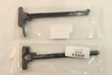 Two AR-15 charging handles.