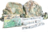 Two military camo helmet covers, three military helmet liner bands, and one camo vinyl pancho new in