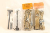 Two Khaki colored nylon rifle slings and two AR-15 charging handles, all new in pkg