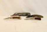 Bag containing four folding pocket knives, one Magnum 2