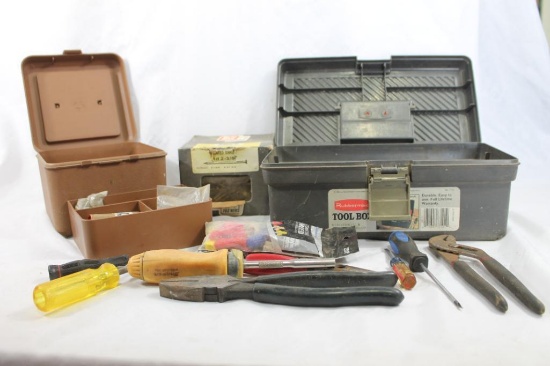 Two small plastic tool boxes with a few tools and 2 boxes of nails