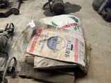 pile of seed sacks, poly tarps