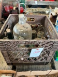 Milk crate containing glass jug