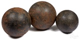 Three cast iron cannon balls