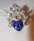 Sterling Ring Aztec style face of carved purple stone and blue topaz and amethyst gems