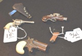 Grouping of vintage cap and toy guns: MIghty MIdget with holster, paratrooper,