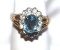 Beautiful Ladies Cocktail ring with Blue topaz center stone, gold colored setting