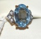Fancy Ladies Ring with large Blue Topaz Center stone and side accents marked 18K HGE
