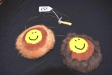 Handmade pair of round face pendants of seal fur on cord to hang from neck