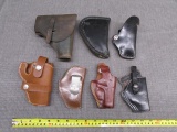 6 leather holsters and a pistol case, all previously used with