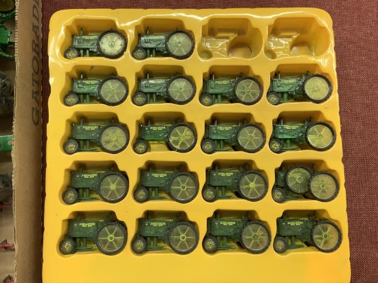 4 John Deere Die cast toy tractors and 18 plastic tractors,