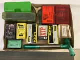 reloading lot with bullets and ammo cases,