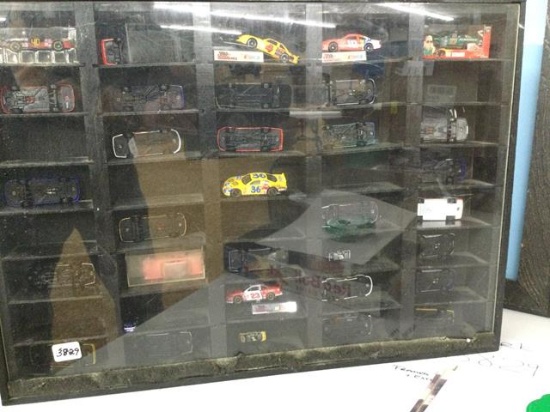 wall hanging shadow box with 33 nascar cars inside