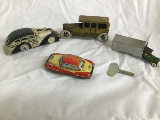 4 small tin litho cars - 1 in garage - all 1 $$