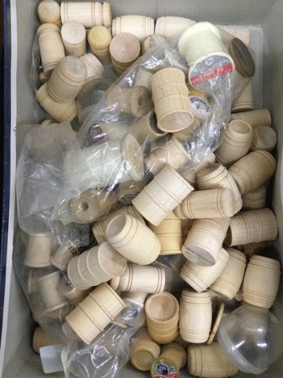 box full of wooden barrels and thread spools