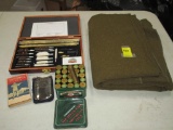 Lot including military blanket, 12 gauge brass ammo, hunting pocket heater and gun cleaning kit