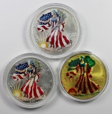 THREE COLORIZED AMERICAN SILVER EAGLES