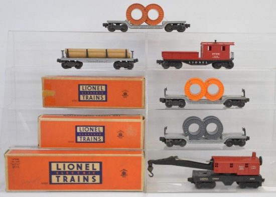 Group of Lionel postwar O gauge crane, flats with loads and work caboose