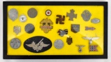 Grouping of Nineteen WWII German Nazi Pins and Insignia in Riker Frame