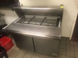 McCall Stainless steel prep table with coffin type top. Under counter refrigeration