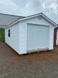 WHITE OUTBUILDING WITH GARAGE DOOR