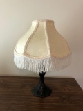 Metal dresser lamp with fringed shade