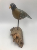 Handmade gamebird decoy on log