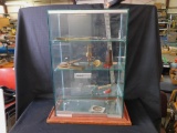GLASS DISPLAY CASE, THREE SHELVES WITH CONTENTS, SLIDING DOORS