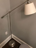 Brushed stainless flex arm floor reading lamp.