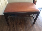Wooden dressing bench with padded seat.