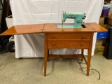 Sewing Table with White Sewing Machine and Chair