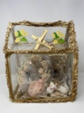 House Shaped Container with Figures, Artificial Flowers and Woven Palm Cross