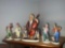 4 Ceramic Clown Figures and Larger Musical Figure of Man Playing Cello