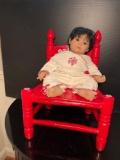 Red Painted Antique Child's Chair and Black Haired Baby Doll