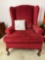 Red Upholstered Wing Chair with Throw Pillow