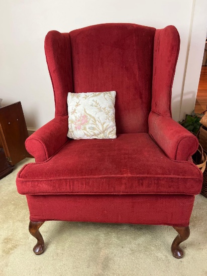 Red Upholstered Wing Chair with Throw Pillow