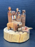 Carving of Native Americans with Bison by Paul Sand
