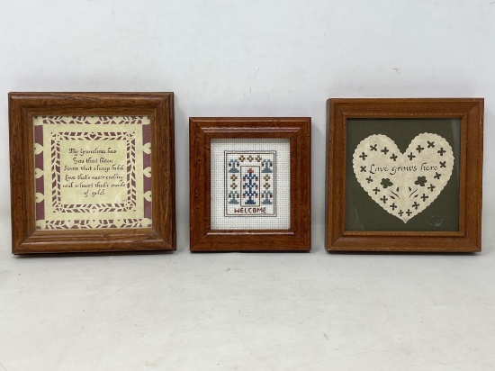 Three framed hand-crafted wall hangings