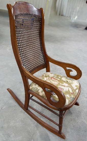 ANTIQUE CANED-BACK ROCKER W/ UPHOLSTERED SEAT