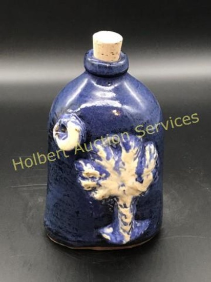 Blue and white Palmetto Moonshine pottery flask with cork