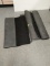 Several rolls of long rugs