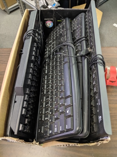 Box of assorted USB computer keyboards